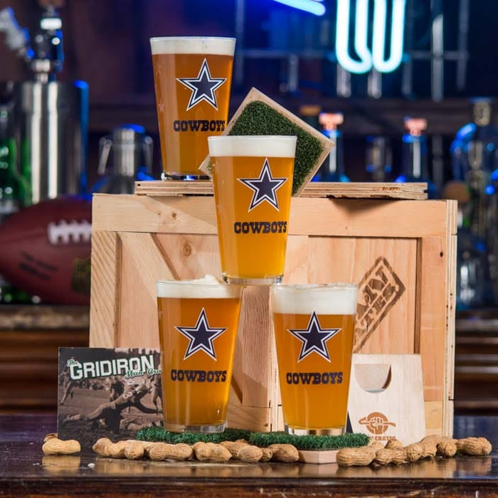 Dallas Cowboys NFL pint glasses, snacks, coasters and a crate.