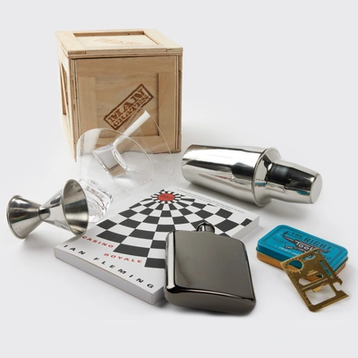 Storied Spy Cocktail Crate includes Casino Royale by Ian Fleming, brined olives, martini glasses, cocktail shaker, jigger, pourer, recipe book, and a credit card tool.