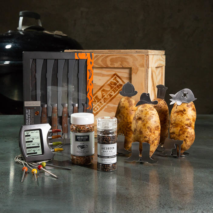 Steaks On A Plate Crate includes a steak knife set, seasoning salts, digital steak thermometer, and decorative potato accessories.