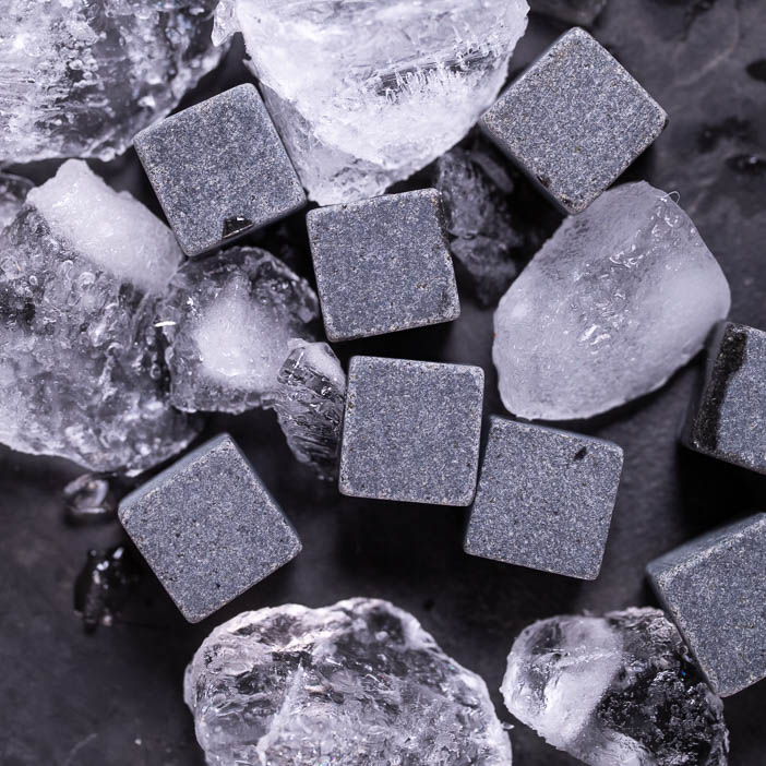 Whiskey stones shown with ice are a great men's drink gift.