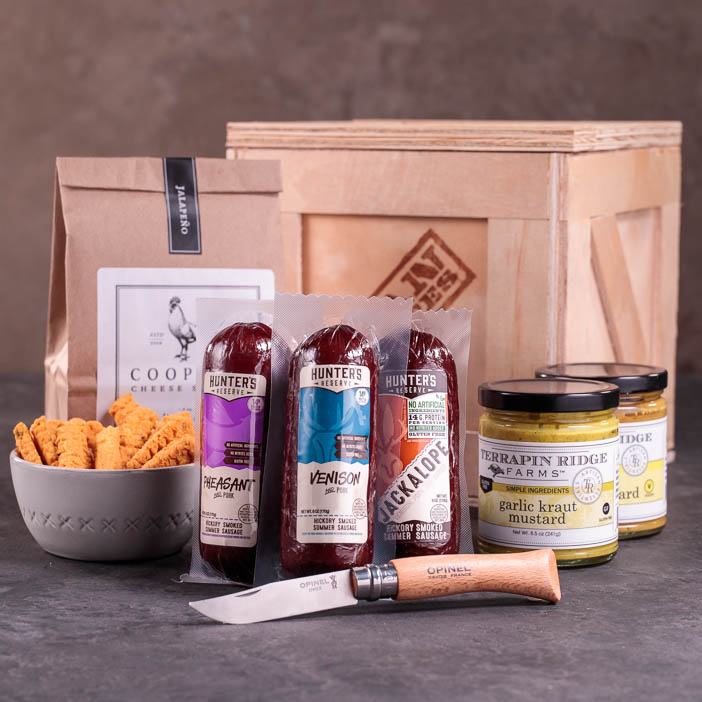 Sausages, spreads, and a knife with crate for men's snack gift.