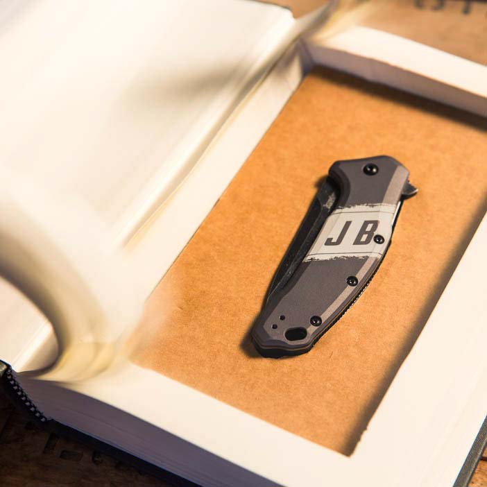 Folding knife concealed in a hollowed out book.