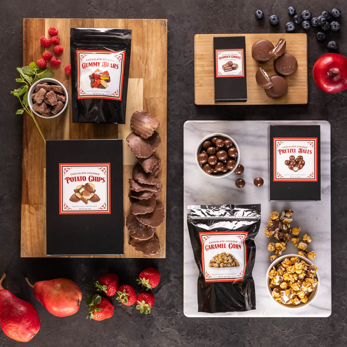Overhead view of Chocolate covered potato chips, nuts, popcorn, and cookies is a great men's snack gift.