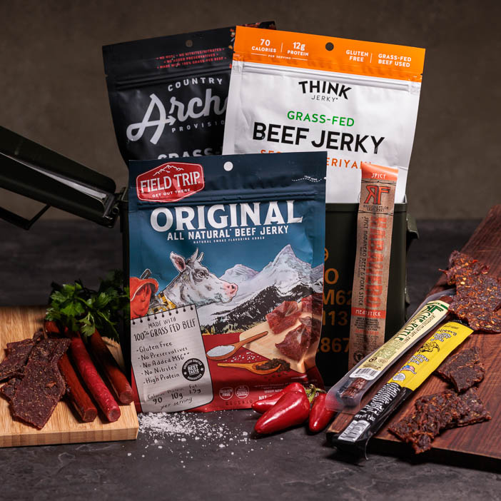 Collection of delicious, assorted jerkies sitting inside an ammo can.