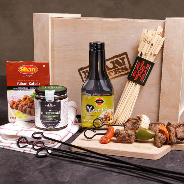 Meat skewers, sauces, rubs, a towel, and kebabs for a great men's grilling gift.