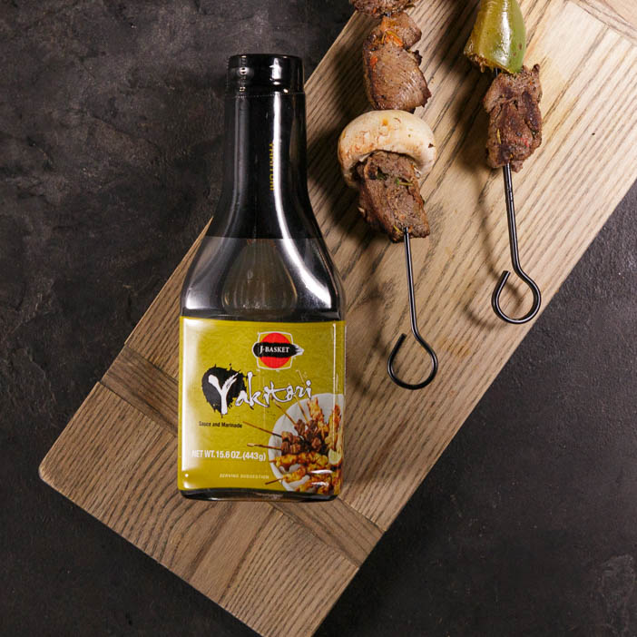 Yakitori sauce bottle with meat skewers for a great men's grilling gift.