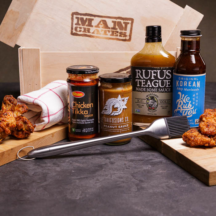 Sauces, brush, wings, and a crate make a great men's cooking gift.