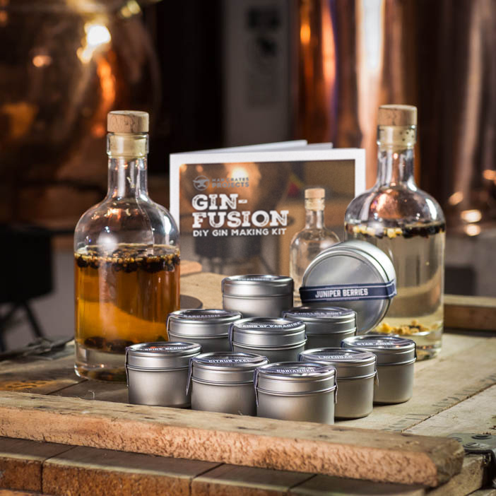 Personalized Gin-Fusion Kit includes glass bottles, bar-top corks, instructional booklet, and an assortment of botanicals and aromatics.