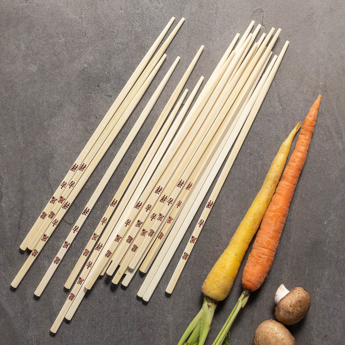 Chopsticks shown with carrots are a great men's cooking gift.
