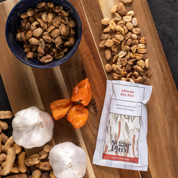 Piri Piri nuts on a cutting board is a great men's snack gift.