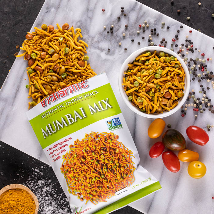 Mumbai snack mix on a cutting board is a great men's snack gift.