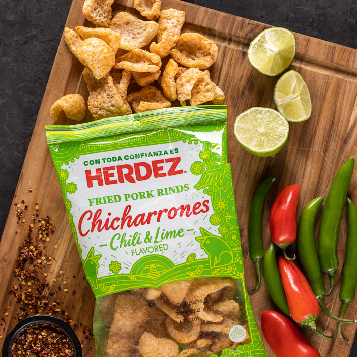 Chile and Lime chicharrones on a cutting board is a great men's snack gift.