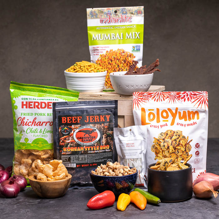 Various snacks on cutting boards is a great men's snack gift.