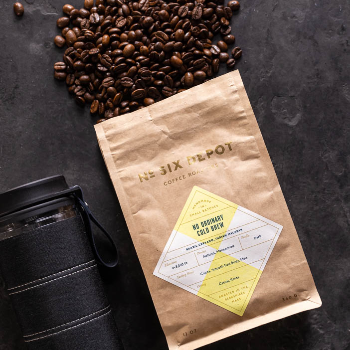 Six Depot coffee beans spilling onto table for a great men's drink gift.