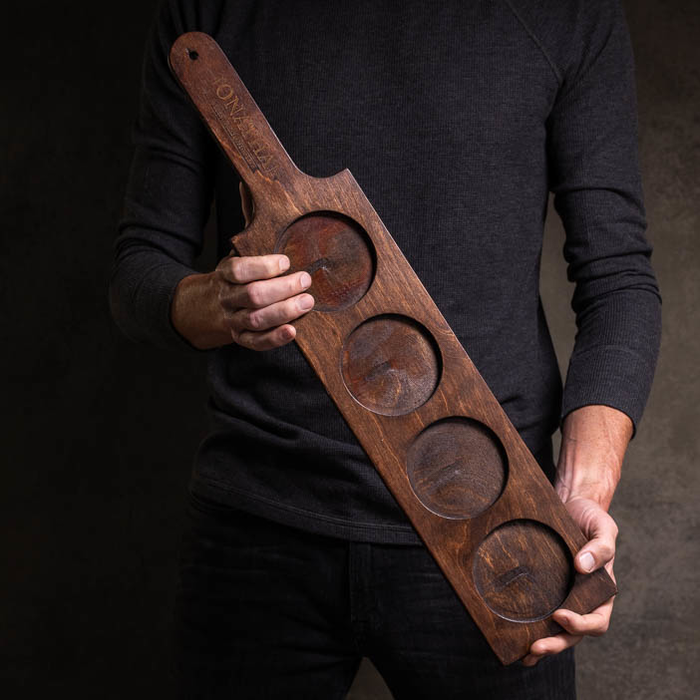 Man holding serving paddle for a great men's whiskey gift.