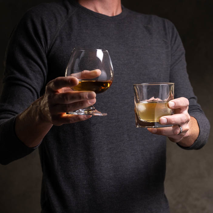 Man holding Rocks and Snifter glasses for a great men's whiskey gift.