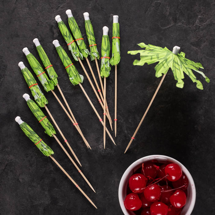 Vacation cocktail classics on his very own kitchen island, topped with tiki cocktail umbrellas.